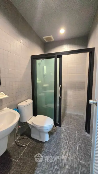 Modern bathroom with glass shower door and sleek fixtures