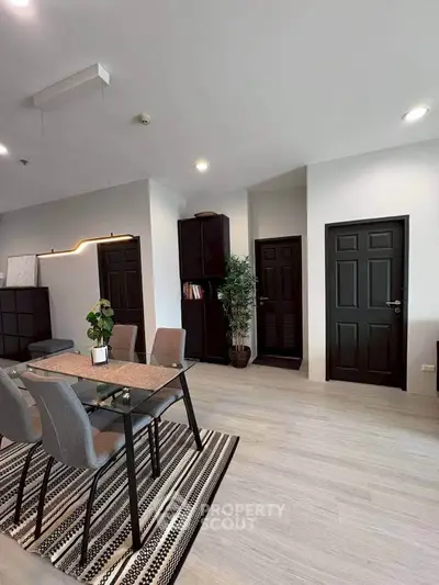 Modern dining area with sleek furniture and stylish decor in a contemporary apartment.