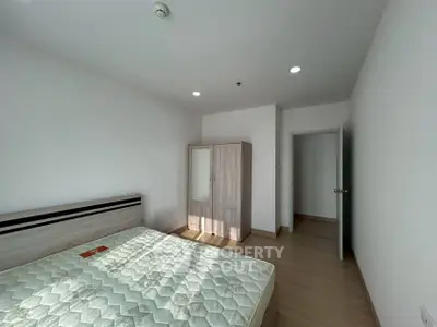 Spacious bedroom with modern wooden furniture and natural light