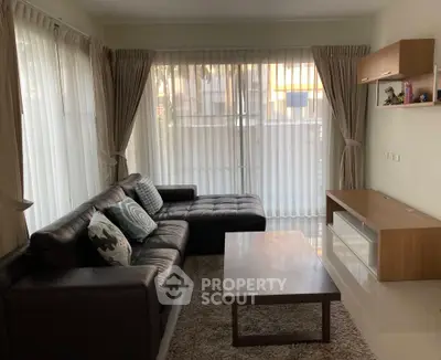 Cozy living room with modern furniture and large windows for natural light.