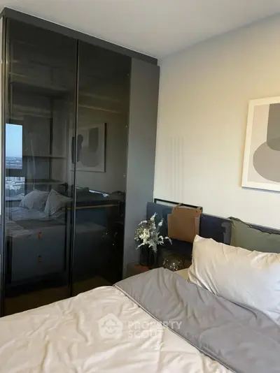 Modern bedroom with sleek glass wardrobe and stylish decor