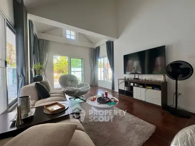 Spacious living room with modern decor and large windows offering natural light.
