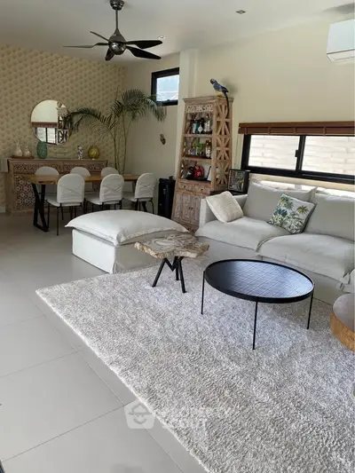 Stylish living room with modern decor, cozy seating, and elegant dining area, perfect for relaxation and entertaining.