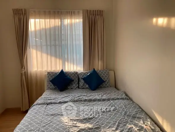 Cozy bedroom with natural light and stylish bedding