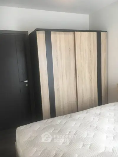 Modern bedroom with sleek wardrobe and comfortable mattress, perfect for a cozy living space.