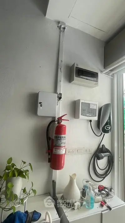 Modern utility area with fire extinguisher and electric vehicle charger
