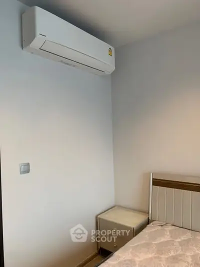 Cozy bedroom corner with air conditioning and modern decor.