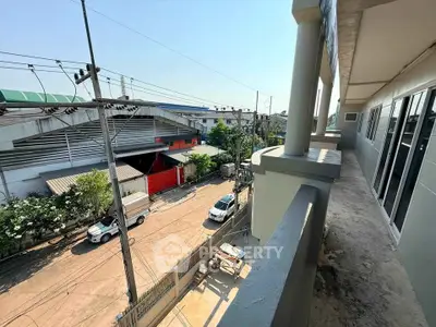 Spacious balcony with urban street view, perfect for enjoying city life and outdoor relaxation.