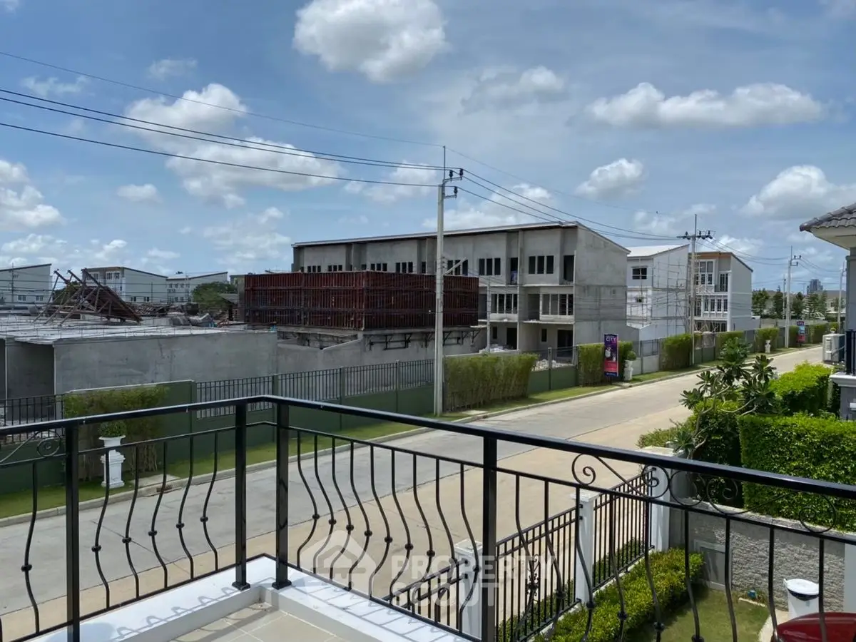 Modern residential neighborhood with under-construction buildings and clear blue sky.