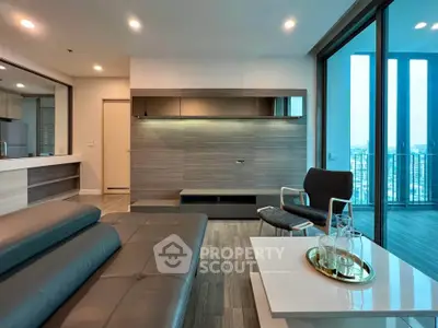 Modern living room with sleek furniture and large windows offering a stunning city view.