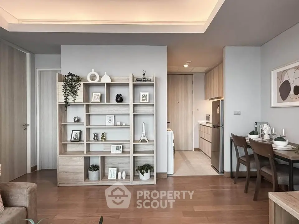 Modern living room with stylish shelving and dining area in open layout apartment.