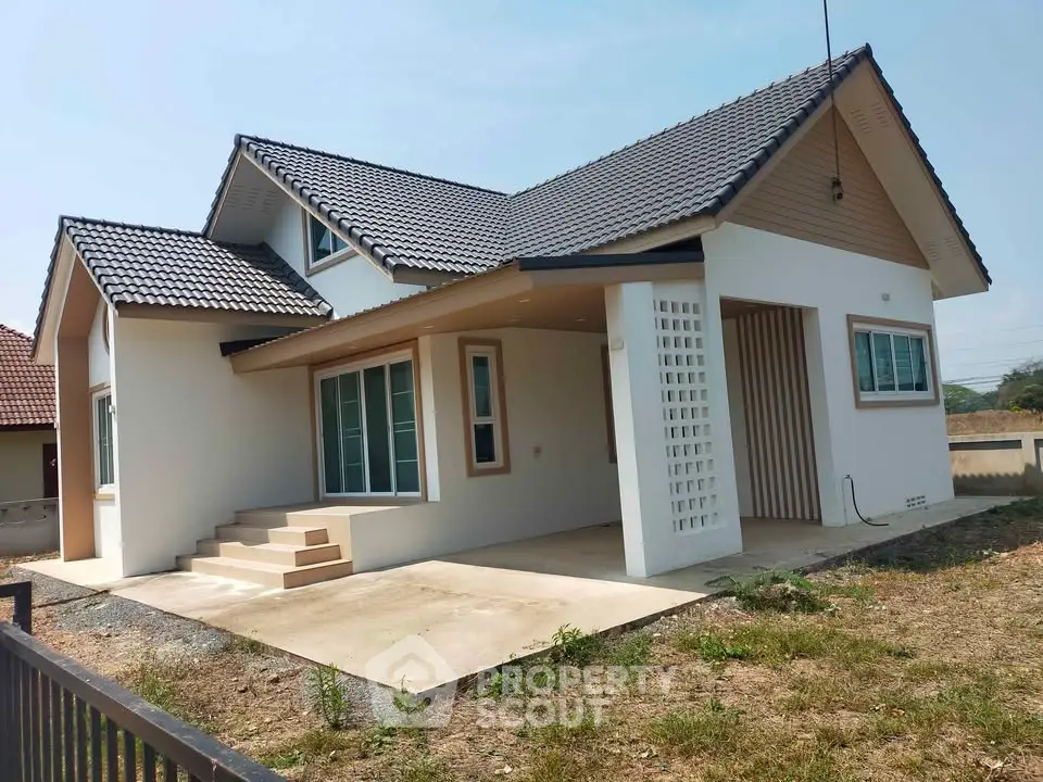 Charming single-story house with modern design and spacious front yard.