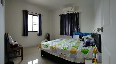 Spacious bedroom with modern decor and natural light