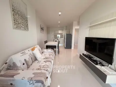 Modern living room with stylish decor and open kitchen layout in a contemporary apartment.