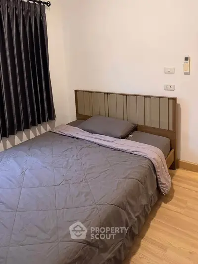 Cozy bedroom with modern decor and comfortable bedding in a stylish apartment.