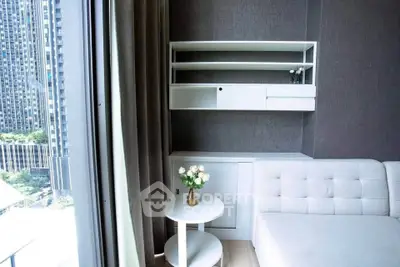 Modern living room with stylish white furniture and large window view in urban apartment.