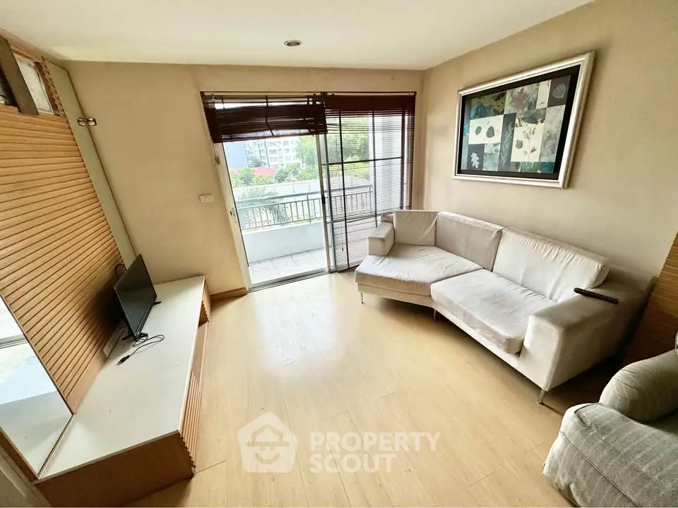 Cozy living room with modern decor and balcony view