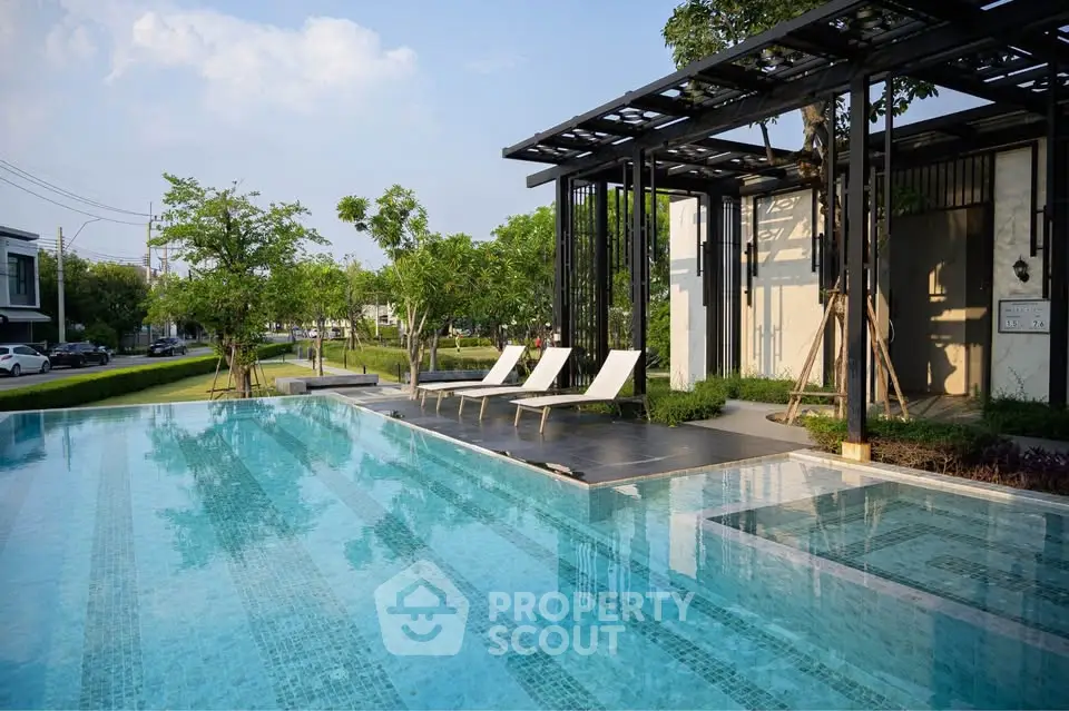 Luxurious outdoor pool area with modern design and sun loungers