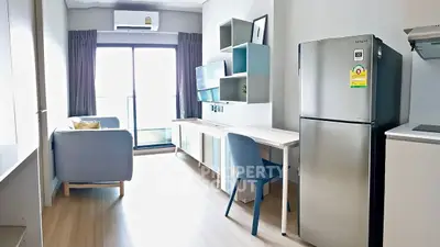 Modern apartment interior with sleek furniture and stainless steel fridge