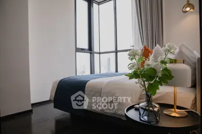 Luxurious bedroom with floor-to-ceiling windows and elegant decor in a modern apartment.