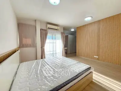 Spacious modern bedroom with wooden accents and natural light