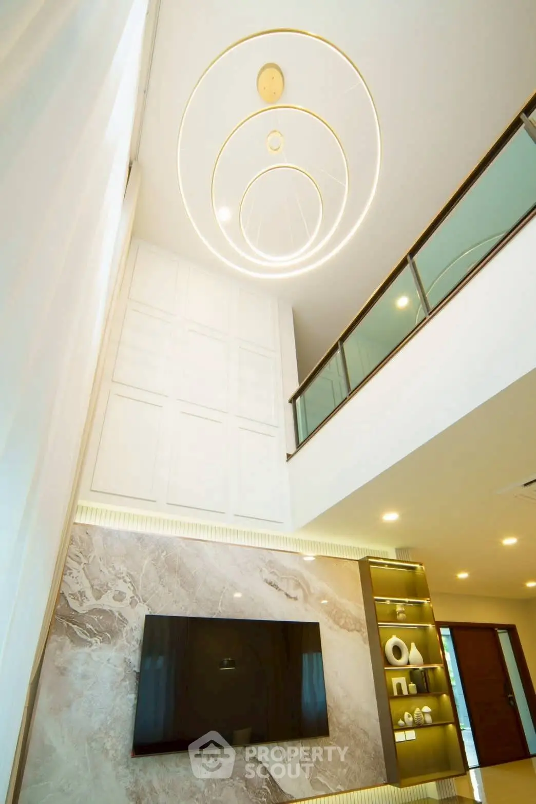 Luxurious modern living room with high ceiling and elegant lighting