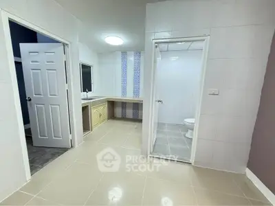Spacious bathroom with modern fixtures and tiled flooring