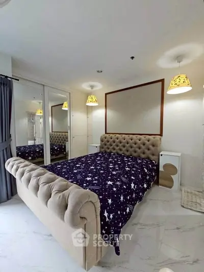 Luxurious bedroom with plush bed and mirrored wardrobe in modern apartment