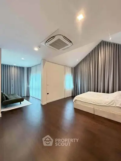 Spacious bedroom with modern design and elegant curtains