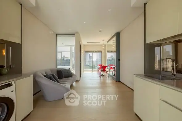 Modern open-plan living room with city view and sleek kitchen design