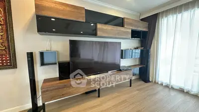 Modern living room with sleek wooden entertainment center and large TV