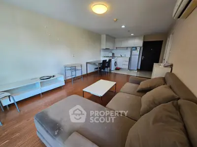 Spacious living room with open kitchen layout and modern furnishings