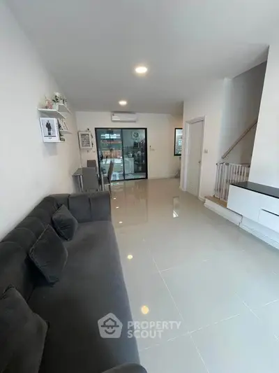 Spacious modern living room with sleek design and ample natural light.