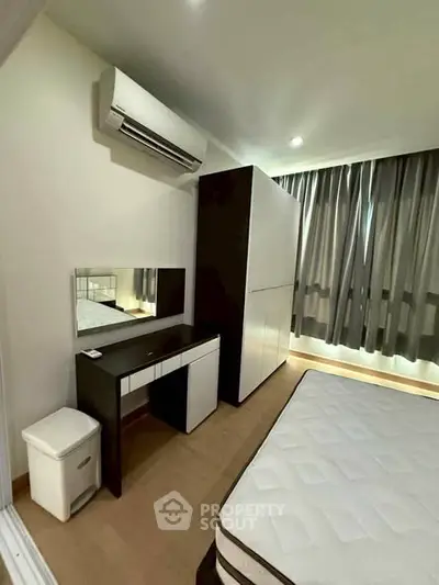 Modern bedroom with air conditioning, wardrobe, and stylish furniture in a cozy apartment.