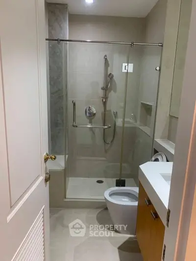 Modern bathroom with glass shower and sleek fixtures