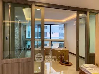 Modern interior with glass sliding doors and natural light, ideal for urban living.