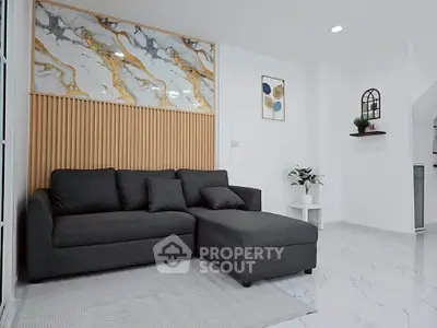 Modern living room with stylish decor and comfortable dark gray sofa.