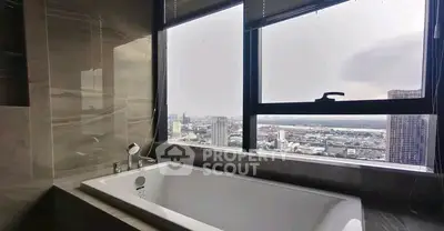 Luxurious bathroom with city view from large window and elegant bathtub.