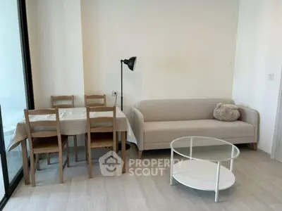 Modern living room with cozy sofa and dining area in bright apartment