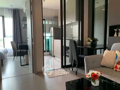 Modern apartment interior with open layout, featuring living room, kitchen, and bedroom.