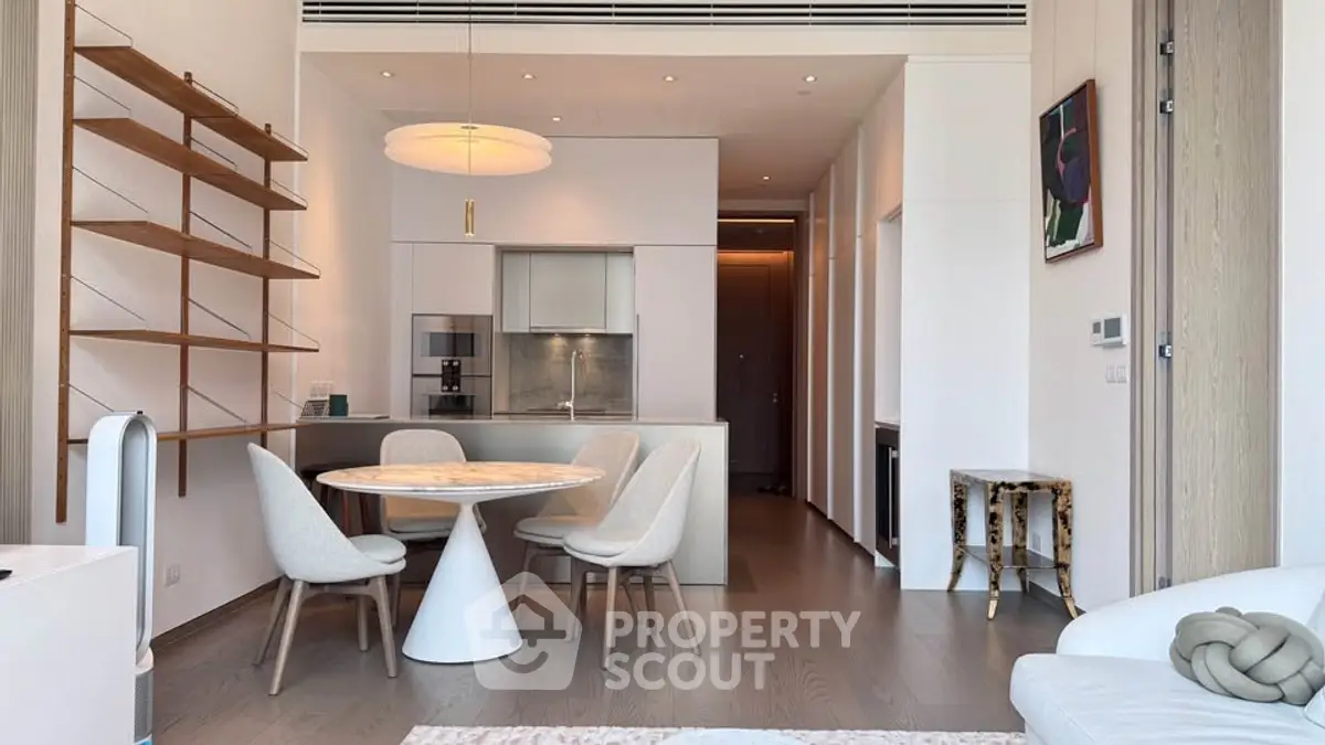 Modern open-plan living room and kitchen with stylish furniture and elegant decor.