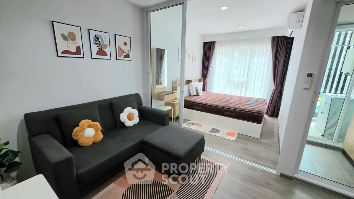 Modern studio apartment with cozy living area and stylish bedroom, featuring elegant decor and natural light.