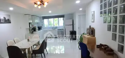 Spacious open-layout kitchen and dining area with modern appliances and elegant decor.