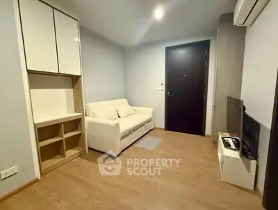 Cozy modern living room with white sofa and wooden flooring