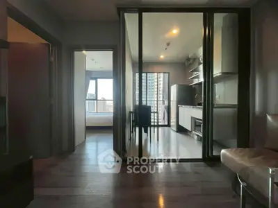 Modern apartment interior with open kitchen and balcony view
