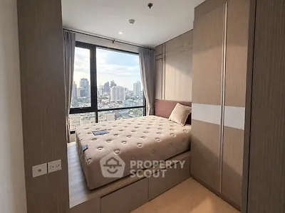 Modern bedroom with city view and built-in storage in high-rise apartment