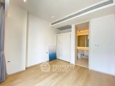 Spacious modern bedroom with ensuite bathroom and wooden flooring