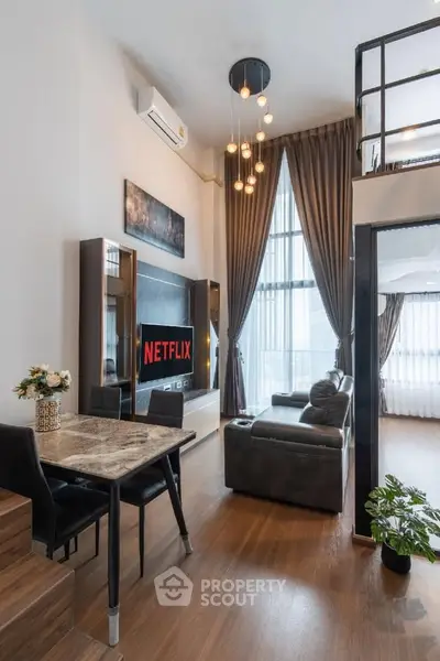 Modern loft apartment with high ceilings, stylish decor, and large windows offering ample natural light.