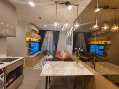 Modern living room with stylish lighting and open layout, featuring a cozy seating area and contemporary decor.