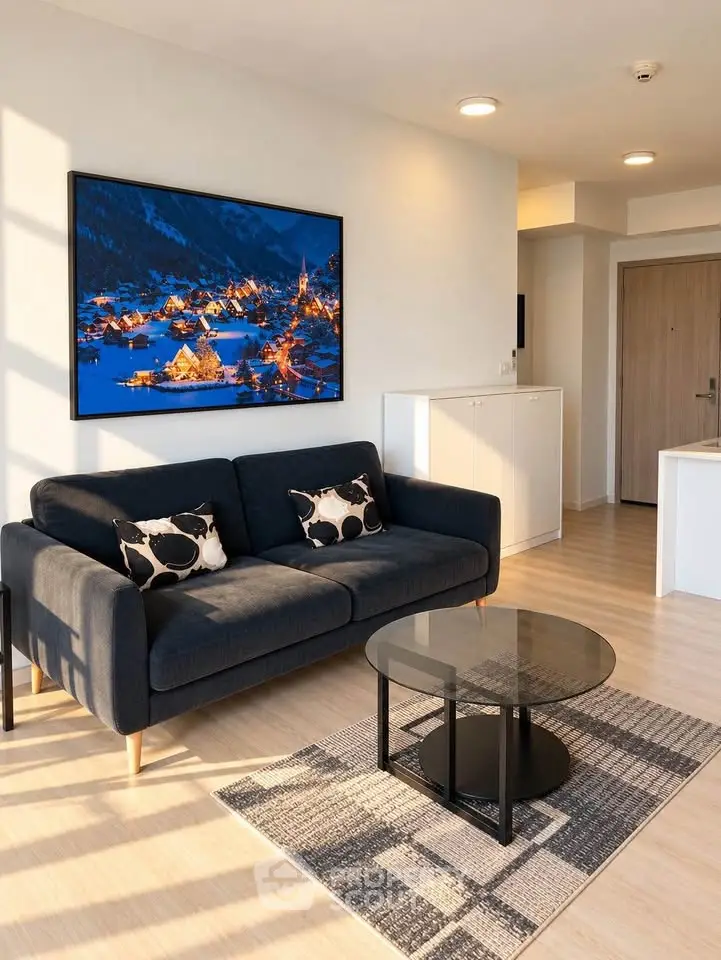 Modern living room with stylish sofa, artwork, and natural light in a contemporary apartment.